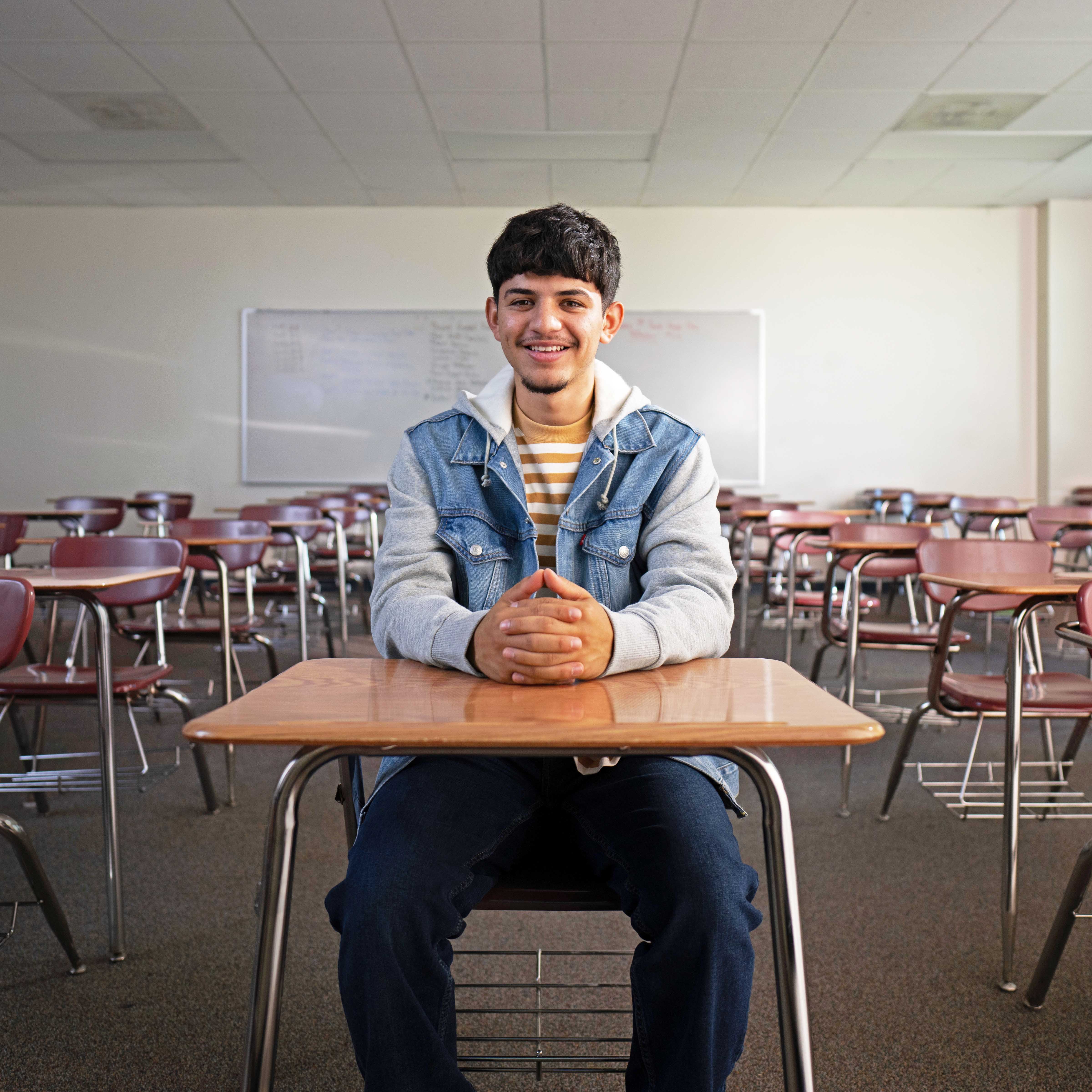 CIS Student at desk in classroom